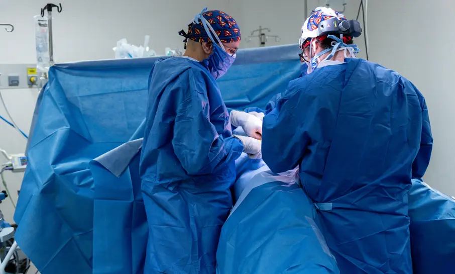 Two surgeons operating on a patient